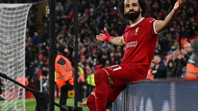 Liverpool's Mohamed Salah celebrates after scoring the opening goal for his side during the English Premier League soccer match against Newcastle at Anfield Stadium in Liverpool, England, on January 1.